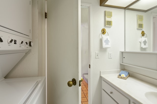 bathroom with tile patterned flooring, vanity, and stacked washer / drying machine