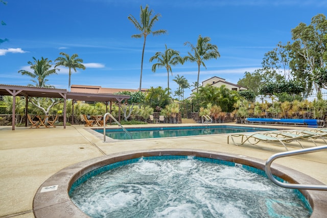 view of pool with a community hot tub and a patio