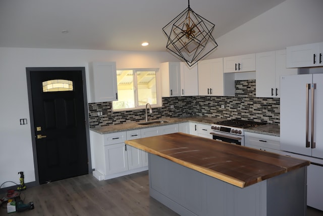 kitchen with a center island, white fridge, white cabinetry, and black gas cooktop