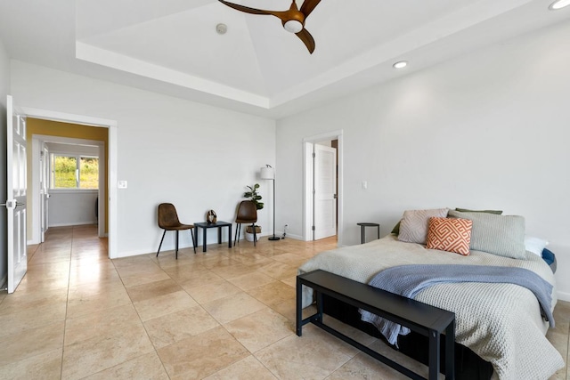 bedroom featuring ceiling fan and a raised ceiling