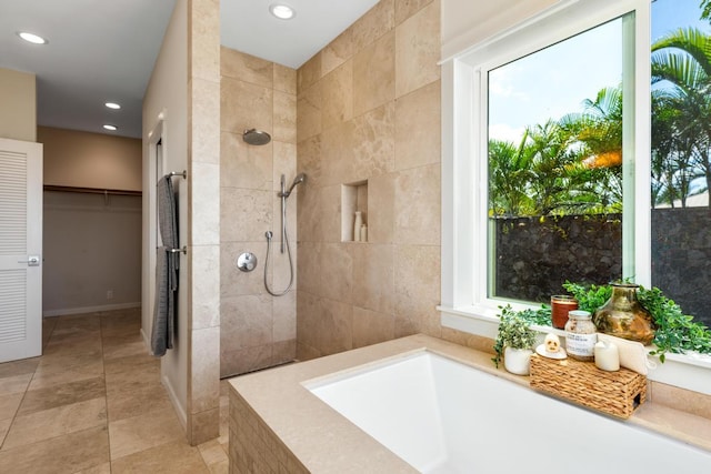 bathroom featuring shower with separate bathtub