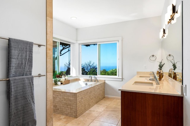 bathroom featuring tiled bath, tile patterned flooring, and vanity