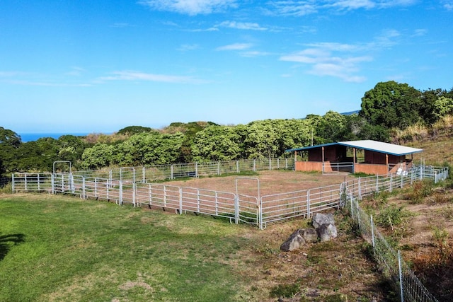 view of yard with an outbuilding and a rural view