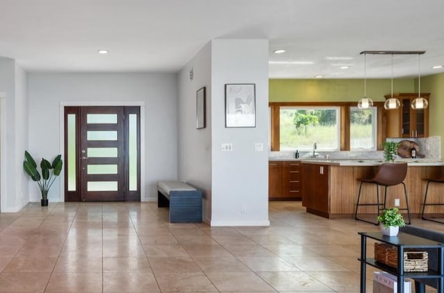 entrance foyer with sink and light tile patterned floors