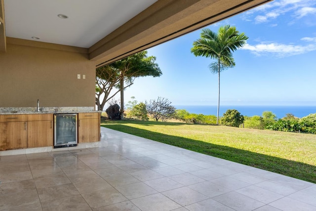 view of patio with sink, beverage cooler, and area for grilling