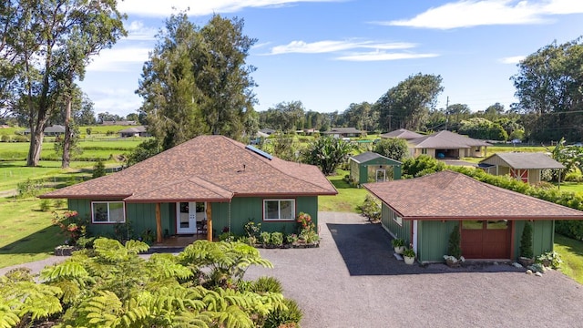 single story home with an outbuilding and a front yard