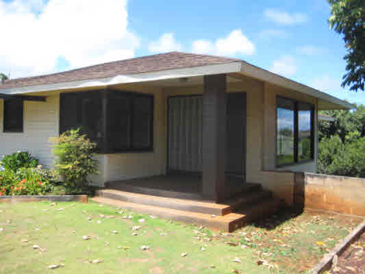 rear view of house with a yard