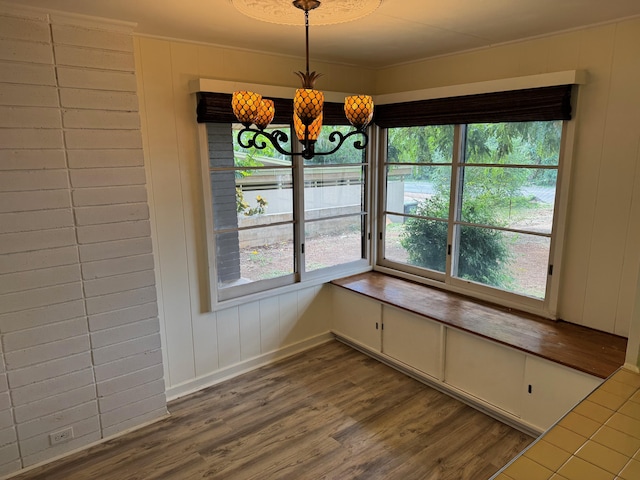 unfurnished dining area with a chandelier and hardwood / wood-style floors