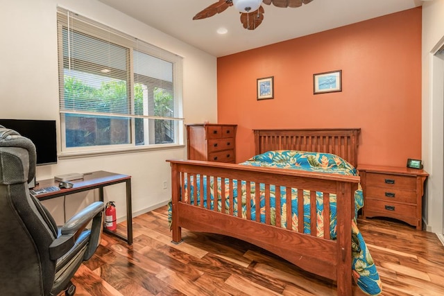 bedroom with hardwood / wood-style flooring and ceiling fan