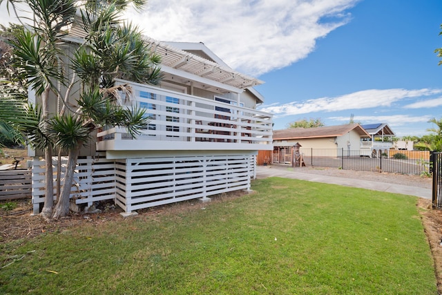 exterior space with a wooden deck and a lawn