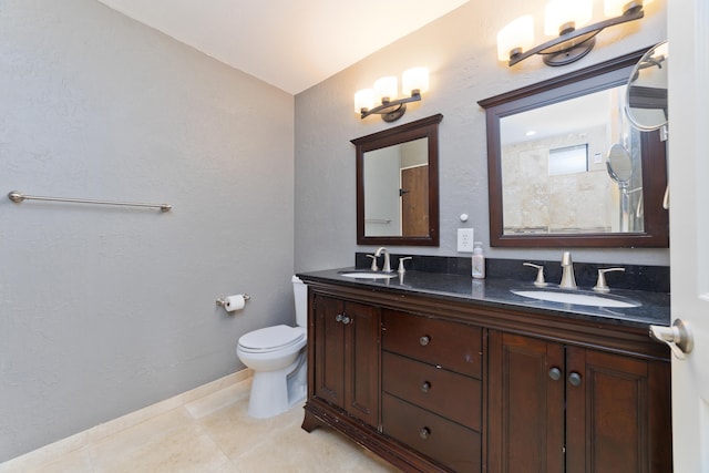 bathroom with tile patterned floors, vanity, and toilet