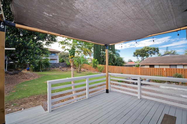 wooden terrace featuring a lawn