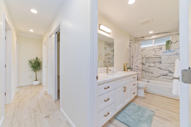 full bathroom with shower / tub combo, vanity, toilet, and hardwood / wood-style floors