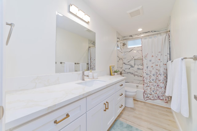 full bathroom with hardwood / wood-style floors, shower / bath combination with curtain, toilet, and vanity