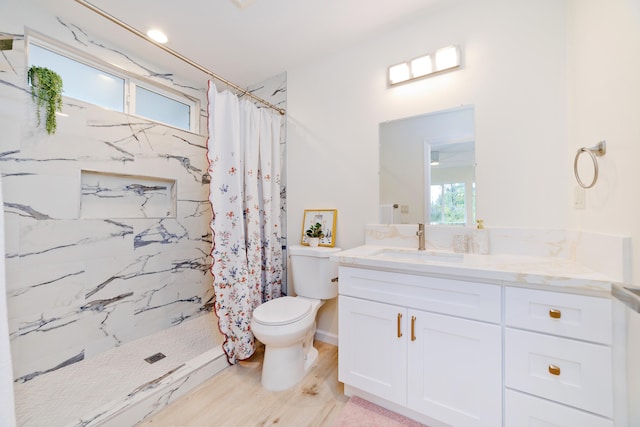 bathroom with a shower with shower curtain, vanity, toilet, and hardwood / wood-style flooring