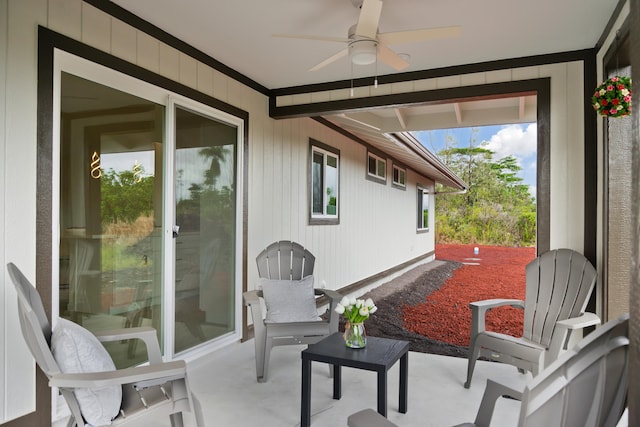 sunroom / solarium featuring ceiling fan