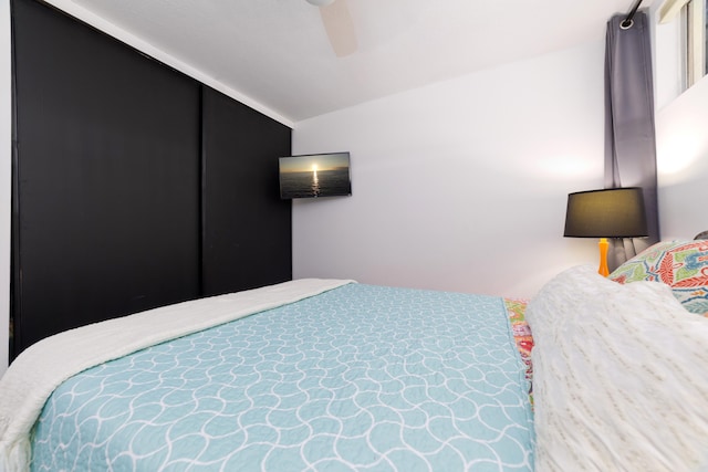 bedroom featuring ceiling fan and lofted ceiling