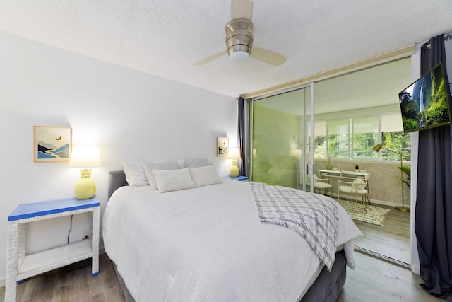 bedroom featuring wood-type flooring, a textured ceiling, ceiling fan, and a closet