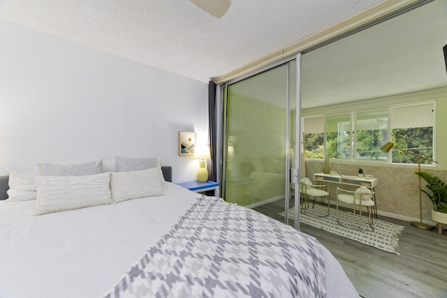 bedroom featuring hardwood / wood-style floors and a textured ceiling