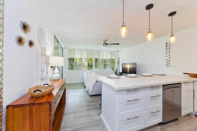 kitchen with white cabinetry, hanging light fixtures, light hardwood / wood-style floors, and butcher block counters