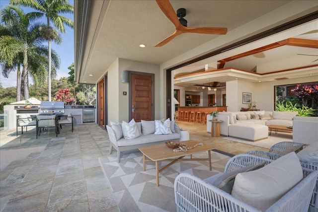 view of patio / terrace featuring an outdoor kitchen, a bar, ceiling fan, area for grilling, and outdoor lounge area