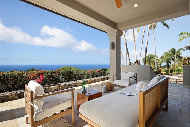 view of patio with ceiling fan and a water view