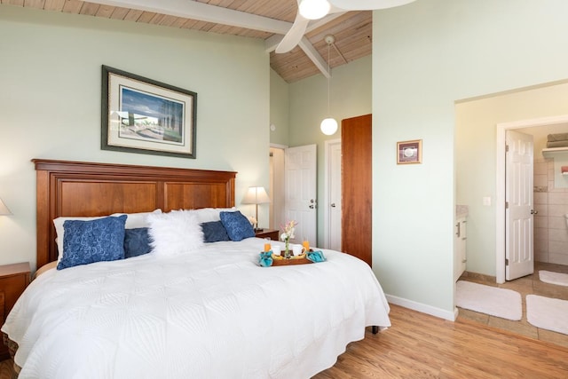 bedroom featuring wooden ceiling, ceiling fan, ensuite bath, beam ceiling, and light hardwood / wood-style flooring