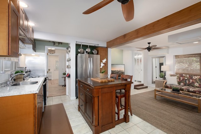 kitchen with beamed ceiling, sink, stainless steel fridge, ceiling fan, and light tile patterned floors