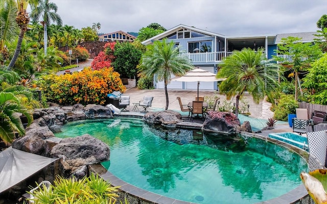 view of pool featuring pool water feature and a patio area