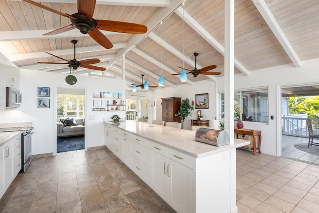 kitchen featuring white cabinetry, appliances with stainless steel finishes, lofted ceiling with beams, and wood ceiling