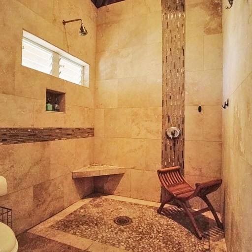 bathroom with toilet and walk in shower