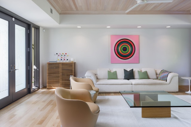 living room featuring ornamental molding, light hardwood / wood-style flooring, wooden ceiling, and french doors