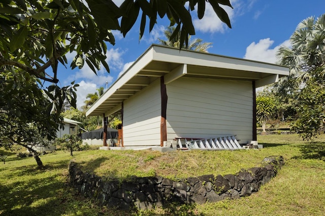 view of home's exterior with a yard