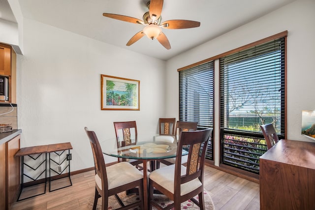 dining room with light hardwood / wood-style floors and ceiling fan