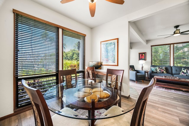 dining area with beamed ceiling, light hardwood / wood-style floors, and ceiling fan