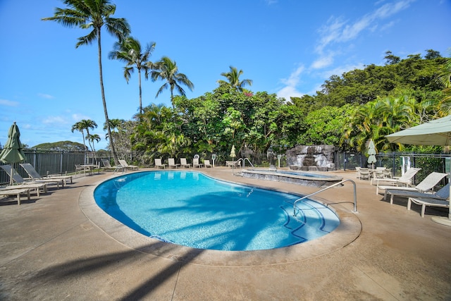 view of swimming pool with a community hot tub and a patio area