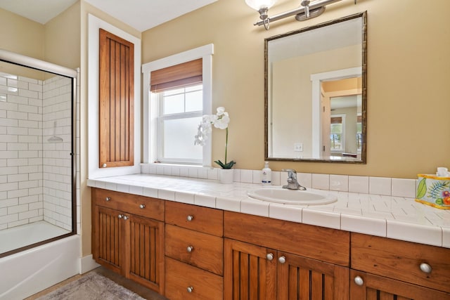 bathroom featuring vanity and combined bath / shower with glass door