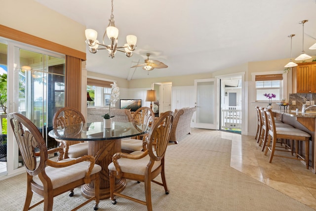 dining room featuring light tile patterned floors, ceiling fan with notable chandelier, and sink