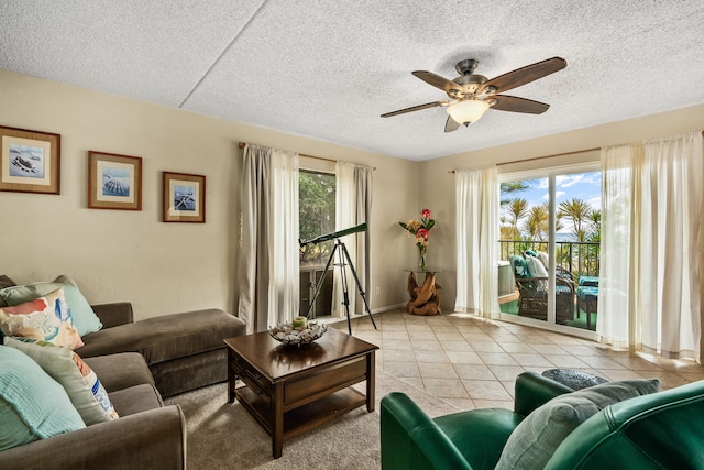 living room with a textured ceiling, light tile patterned floors, and ceiling fan