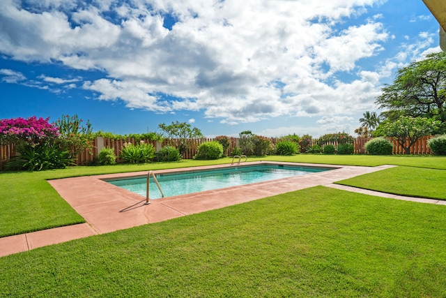 view of pool with a patio area and a yard