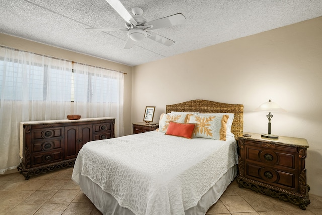 tiled bedroom featuring ceiling fan and a textured ceiling