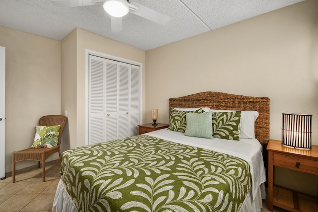 tiled bedroom featuring a textured ceiling, a closet, and ceiling fan