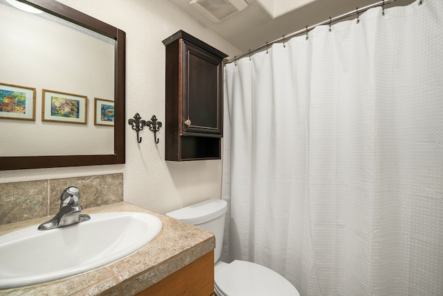 bathroom with toilet and vanity