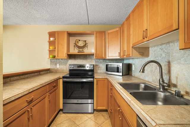 kitchen featuring sink, stainless steel appliances, backsplash, and light tile patterned flooring