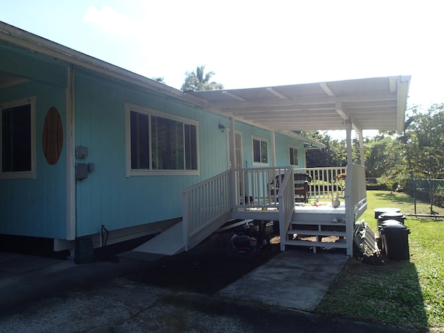 view of side of property featuring a wooden deck