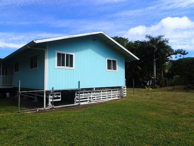 view of property exterior with a lawn