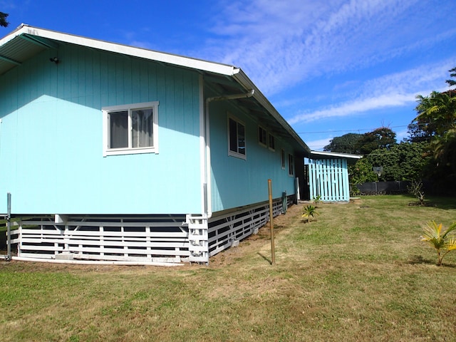 view of side of property with a yard