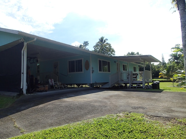 view of front of home with a porch and a carport