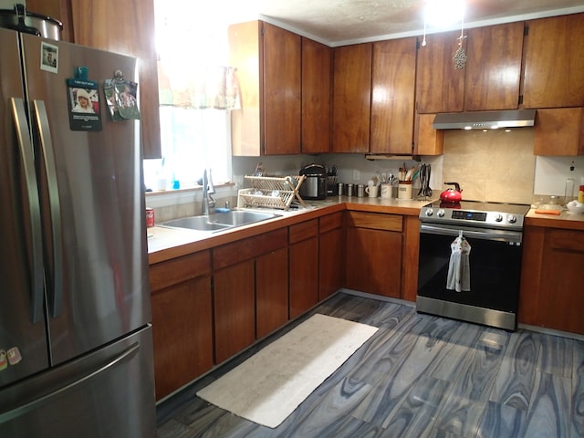 kitchen featuring appliances with stainless steel finishes, sink, and dark hardwood / wood-style flooring