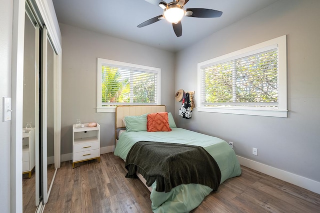 bedroom with ceiling fan, a closet, and dark hardwood / wood-style flooring